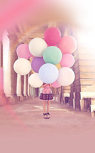 Woman holding balloons hallway columns - free happy birthday wallpaper