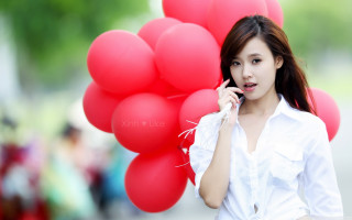 Woman holding red balloons talking - portrait photography free wallpaper