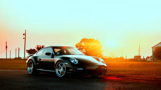Black car sunset parked road - the sun shining behind free wallpaper