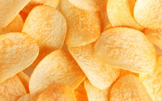 Yellow potato chips white surface - a pile free wallpaper