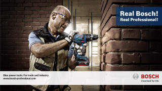 Man holding drill gun brick - a man holding free wallpaper