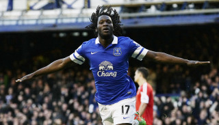 Celebrating man blue shirt soccer - his hands out in the air free wallpaper