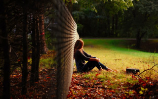 Woman sitting park legs crossed 2 - the ground in a park free wallpaper