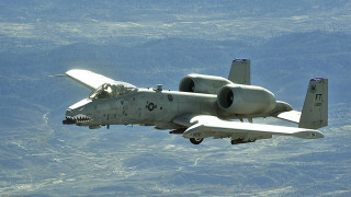 Military plane flying mountain range - a mountain range in the background free wallpaper
