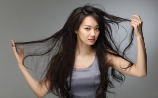 Woman long hair holding hair - flowing hair free wallpaper