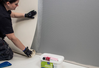 Woman painting wall paint roller - the floor next free wallpaper