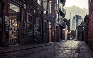 Narrow street brick building clock - a narrow street free wallpaper