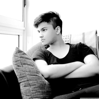 Man sitting couch arms crossed - a man free wallpaper