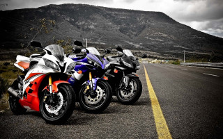 Motorcycles parked road mountain range 3 - a cloudy sky free wallpaper