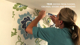 Woman painting wall flower pattern - a quote above free wallpaper