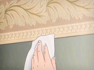 Person wiping wall cloth hand - a cloth free wallpaper