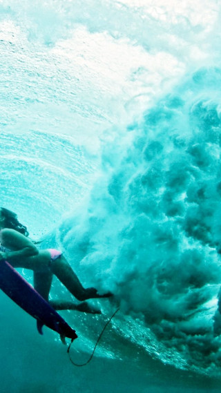 Woman surfing ocean wave helmet - her hand and a helmet free wallpaper