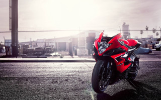 Red motorcycle parked road fence - a red motorcycle free wallpaper