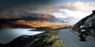 Motorcycle road mountain lake background - a motorcycle free wallpaper