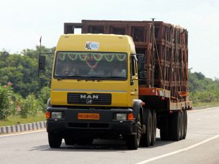 Yellow truck driving road forest - a yellow truck free wallpaper