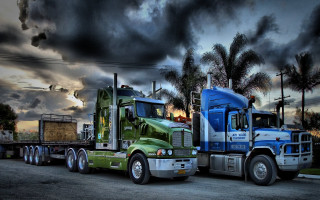Semi trucks parked cloudy sky 2 - palm tree free wallpaper