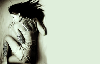 Woman tattoos bed pillow sheets - her arm and leg free wallpaper