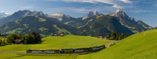 Train green countryside mountains forest - a mountain range in the background free wallpaper