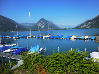 Boats water mountains bushes docked - a few boat free wallpaper