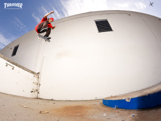 Man skateboard white building blue - a white building free wallpaper