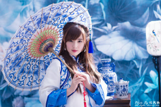Woman umbrella blue white wall - an umbrella in front free wallpaper
