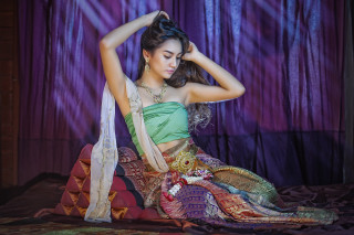 Woman green dress sitting bed 2 - a bed free wallpaper