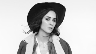 Woman hat jacket portrait blackwhite - a white wall behind her free wallpaper