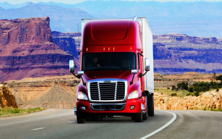 Red semi truck mountain road - a red semi truck free wallpaper