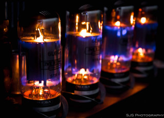 Glass tubes lit candles table - a table top free wallpaper