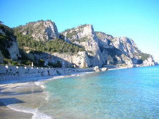 Beach mountain water building foreground - a mountain in the background and a body of water free wallpaper