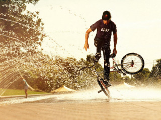 Man bike trick water wheel - a trick free wallpaper