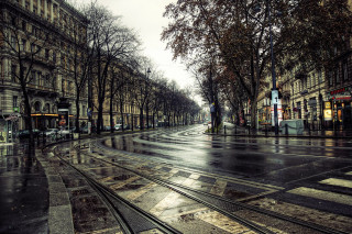 Wet street train track building - gloomy atmosphere free wallpaper