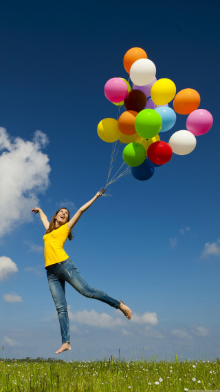Woman yellow shirt holding balloons - free happy birthday wallpaper