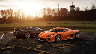 Orange sports cars parking lot - a parking lot free wallpaper