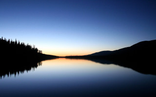Lake trees sunset blue sky - the shore and a sunset in the background free wallpaper