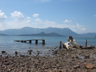 Boat water rocky shore mountains - the water free wallpaper