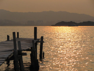 Dock boat water mountains distance - the water free wallpaper