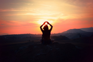Person sitting hill hands sun - their hands in free wallpaper