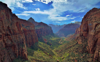 Scenic valley mountains trees sky - a scenic view of a valley free wallpaper