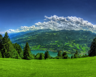 Green field lake mountains clouds - a green field free wallpaper