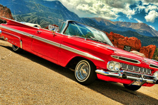 Red car parked road mountains - a mountain range in the background free wallpaper