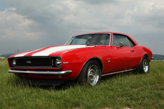Red white car parked grass - cloudy free wallpaper
