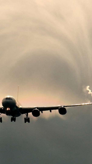 Jetliner cloudy sky smoke tail - a cloudy sky free wallpaper
