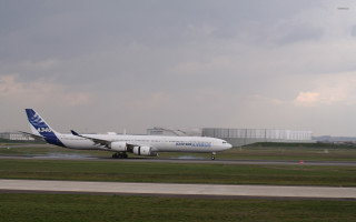 Large white airplane runway building - fluxus free wallpaper