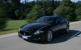 Black car driving road forest 8 - a black car free wallpaper