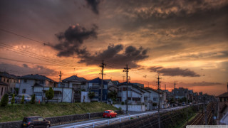 Sunset city red car driving - a few building free wallpaper