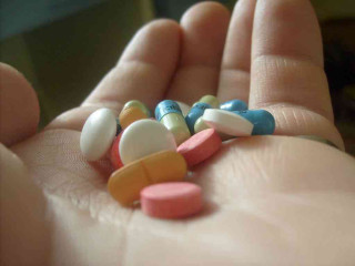 Person holding pills single pill - damien hirst free wallpaper