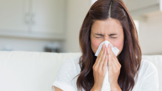 Woman blowing nose tissue couch - a couch in a living room free wallpaper