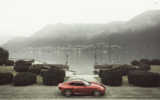 Red car lake bushes mountains - a red car free wallpaper