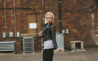 Woman black jacket striped skirt - a skateboard in front free wallpaper
